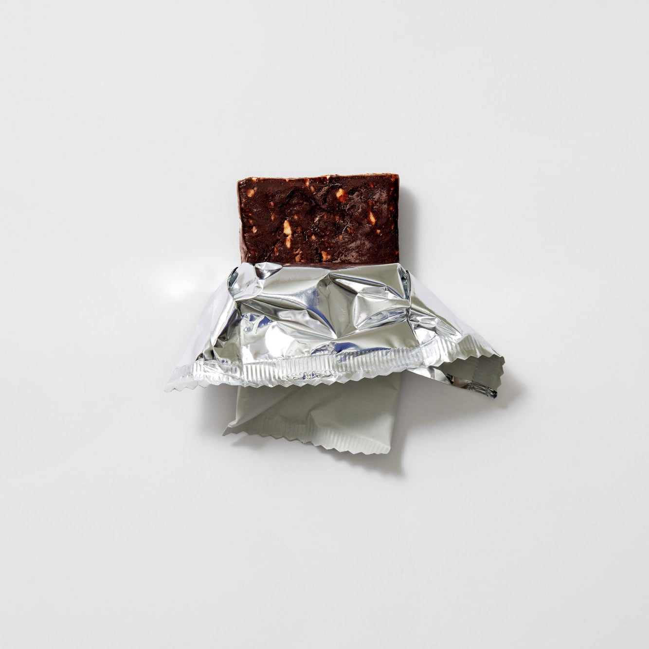 Chocolate bar with a foil wrapper on a white background