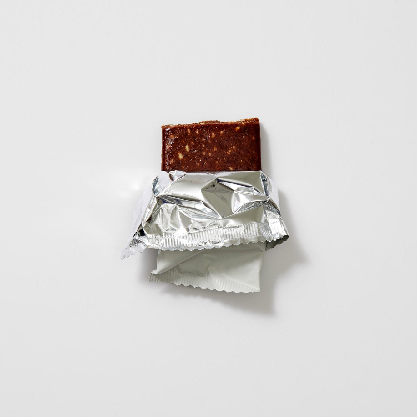 Chocolate bar with a foil wrapper on a white background